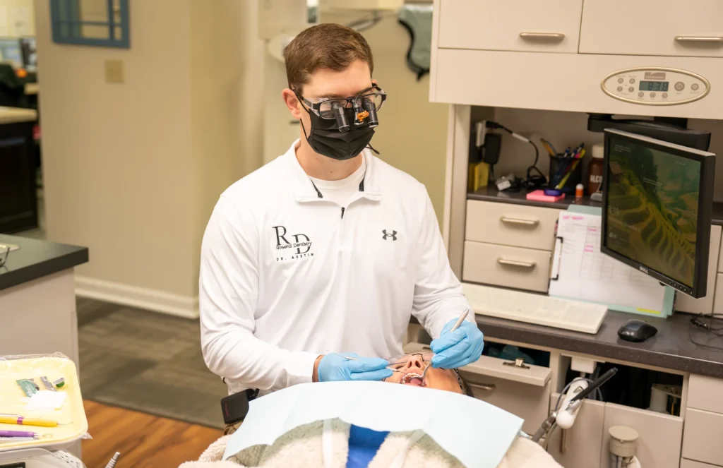 Dr. Austin doing an emergency exam on a patient in the dental chair | Locally-owned emergency dentist in Lenexa, KS